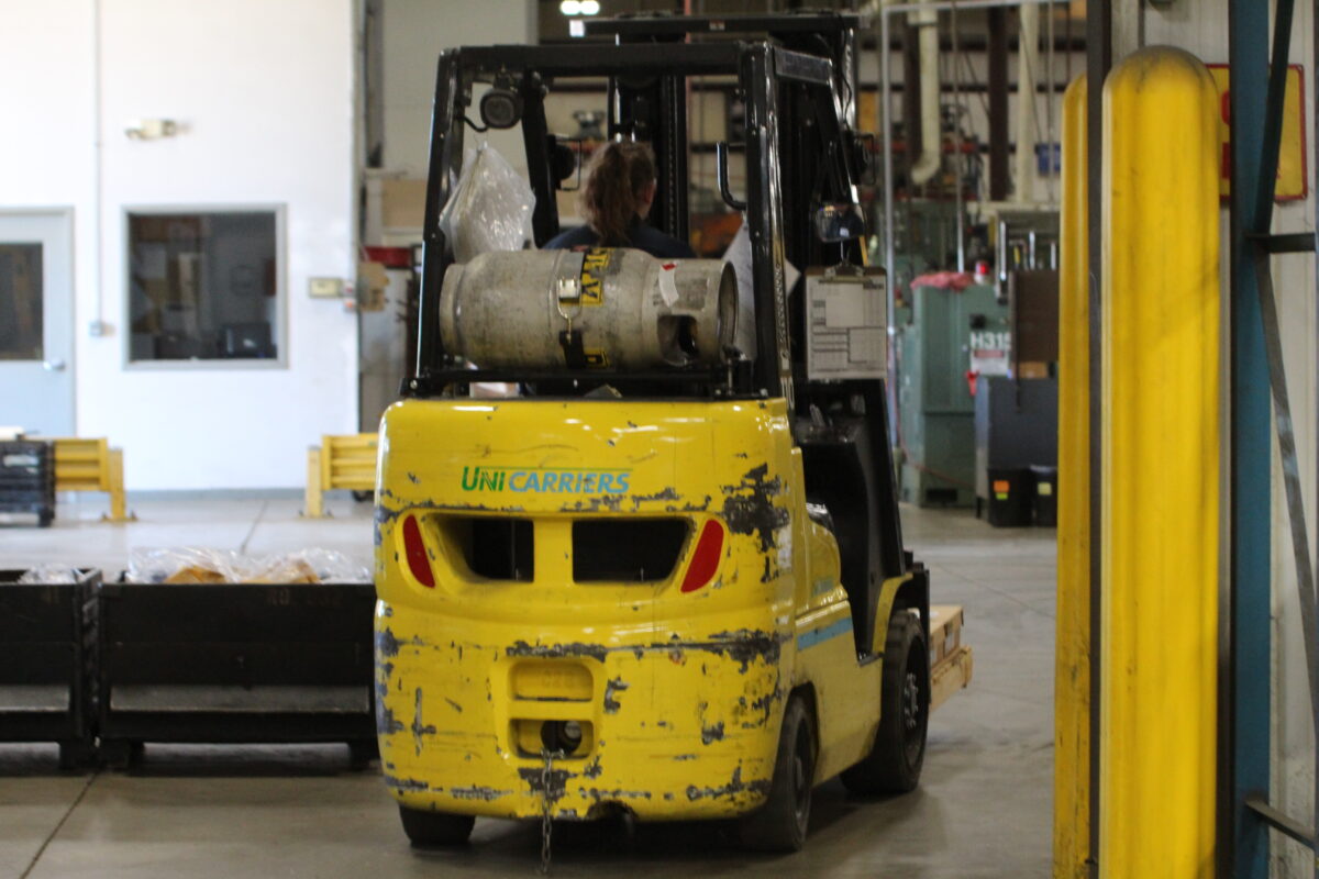 Hi Lo being driven by a material handler in production control department
