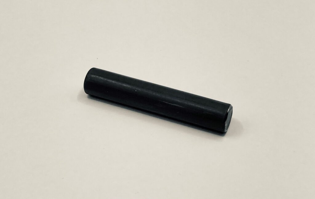 A black dowel pin on a white background.